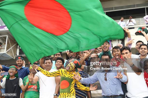 Bangladeshi fans cheer after Bangladesh defeated Australia during day four of the First Test match between Bangladesh and Australia at Shere Bangla...