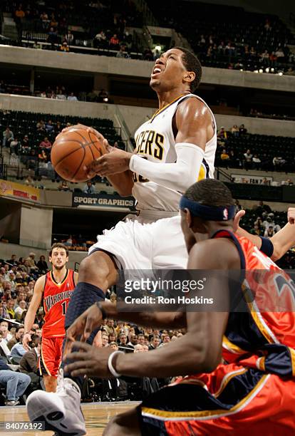 Danny Granger of the Indiana Pacers drives on Anthony Morrow of the Golden State Warriors at Conseco Fieldhouse on December 18, 2008 in Indianapolis,...