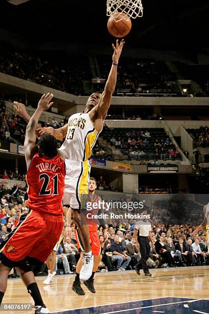 Stephen Graham of the Indiana Pacers shoots over Ronny Turiaf of the Golden State Warriors at Conseco Fieldhouse on December 18, 2008 in...