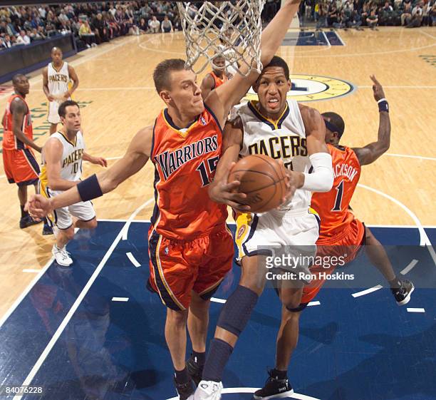 Danny Granger of the Indiana Pacers battles Andris Biedrins of the Golden State Warriors at Conseco Fieldhouse on December 18, 2008 in Indianapolis,...