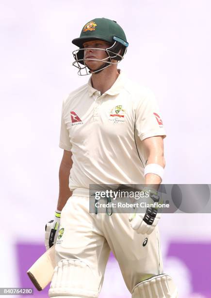 Steve Smith of Australia walks off the ground after he was dismissed by Shakib Al Hasan of Bangladesh during day four of the First Test match between...