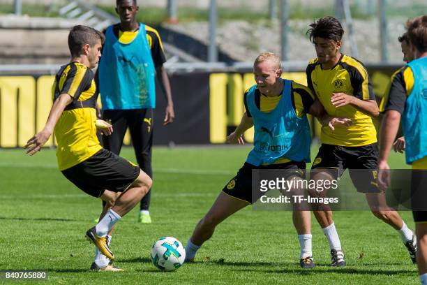 Christian Pulisic of Dortmund , Sebastian Rode of Dortmund and Mahmound Dahoud of Dortmund battle for the ball during a training session as part of...