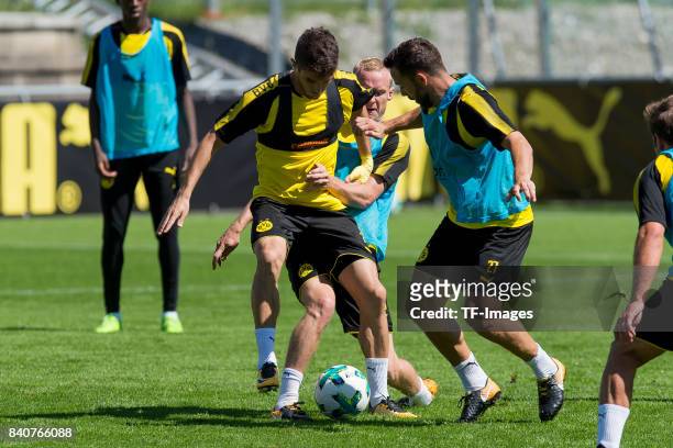 Christian Pulisic of Dortmund , Sebastian Rode of Dortmund and Gonzalo Castro of Dortmund battle for the ball during a training session as part of...