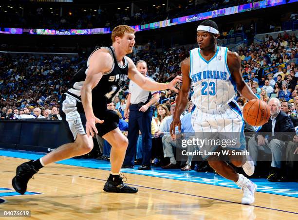 Devin Brown of the New Orleans Hornets drives against Matt Bonner of the San Antonio Spurs at the New Orleans Arena December 17, 2008 in New Orleans,...