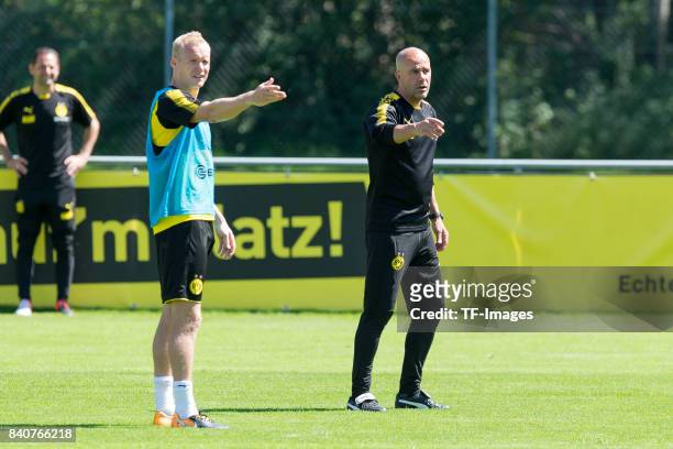 Sebastian Rode of Dortmund and Head coach Peter Bosz of Dortmund gestures during a training session as part of the training camp on July 30, 2017 in...