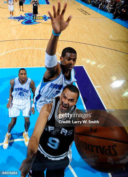 Tony Parker of the San Antonio Spurs shoots past Chris Paul and Rasual Butler of the New Orleans Hornets at the New Orleans Arena December 17, 2008...