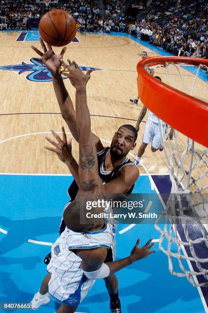 Tim Duncan of the San Antonio Spurs shoots over David West of the New Orleans Hornets at the New Orleans Arena December 17, 2008 in New Orleans,...