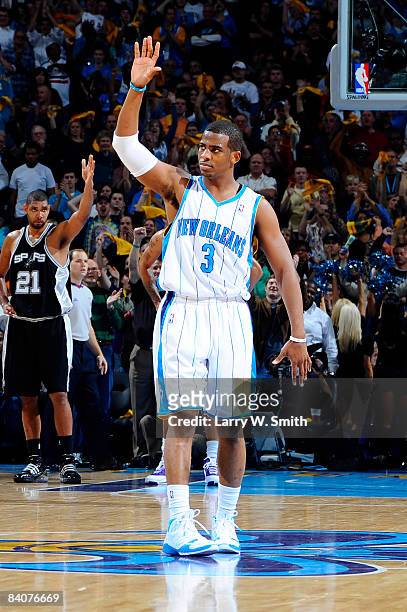 Chris Paul of the New Orleans Hornets acknowledges the crowd after setting a new record for the most consecutive games with a steal after stealing...