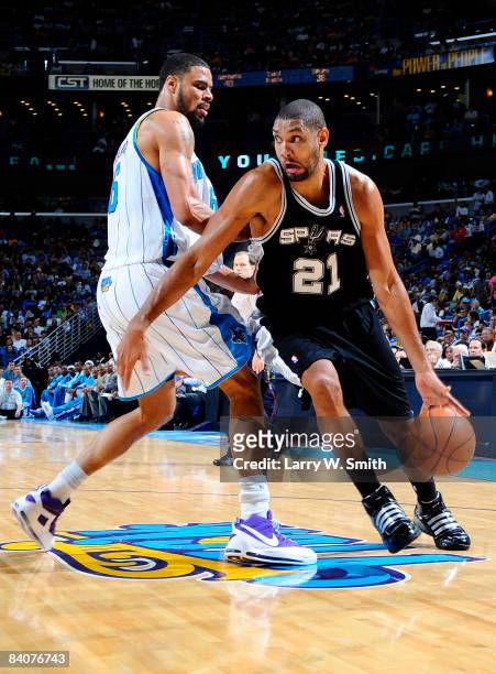 Tim Duncan of the San Antonio Spurs drives past Tyson Chandler of the New Orleans Hornets at the New Orleans Arena December 17, 2008 in New Orleans,...