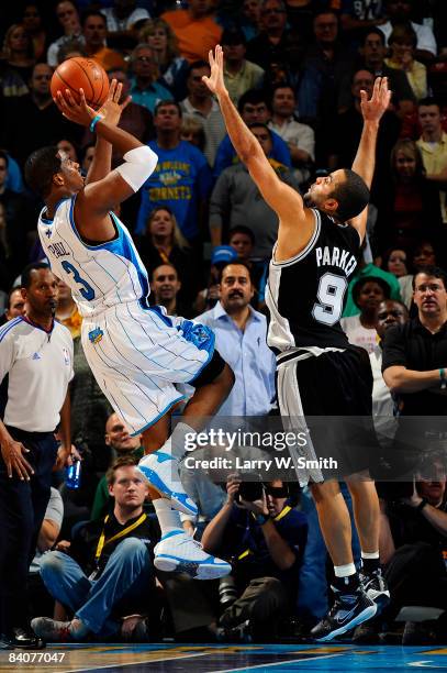 Chris Paul of the New Orleans Hornets shoots over Tony Parker of the San Antonio Spurs at the New Orleans Arena December 17, 2008 in New Orleans,...