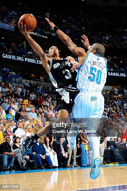 George Hill of the San Antonio Spurs shoots over Antonio Daniels of the New Orleans Hornets at the New Orleans Arena December 17, 2008 in New...