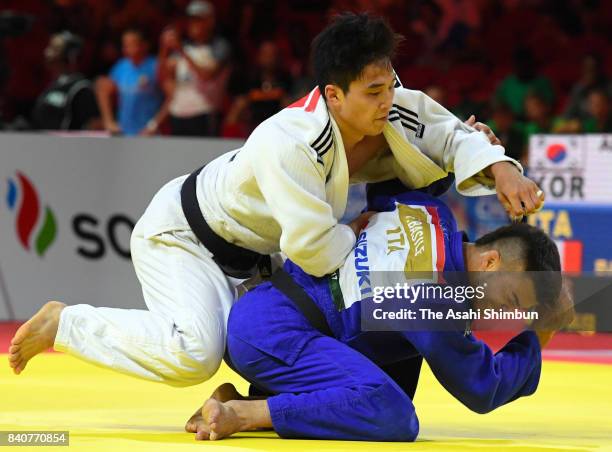 An Baul of South Korea and Fabio Basile of Italy compete in the Men's -66kg third round during day two of the World Judo Championships at the Laszlo...