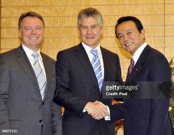Australian Foreign Minister Stephen Smith accompanied by Defense Minister Joel Fitzgibbon shakes hands with Japan's Prime Minister Taro Aso during...
