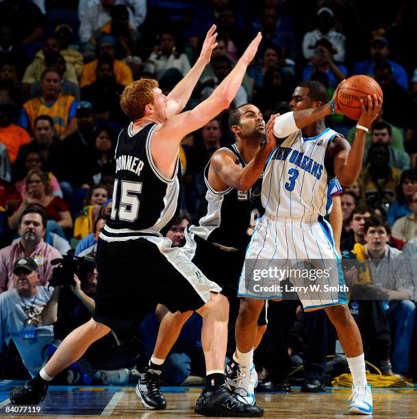 Matt Bonner and Tony Parker of the San Antonio Spurs guard Chris Paul of the New Orleans Hornets at the New Orleans Arena December 17, 2008 in New...