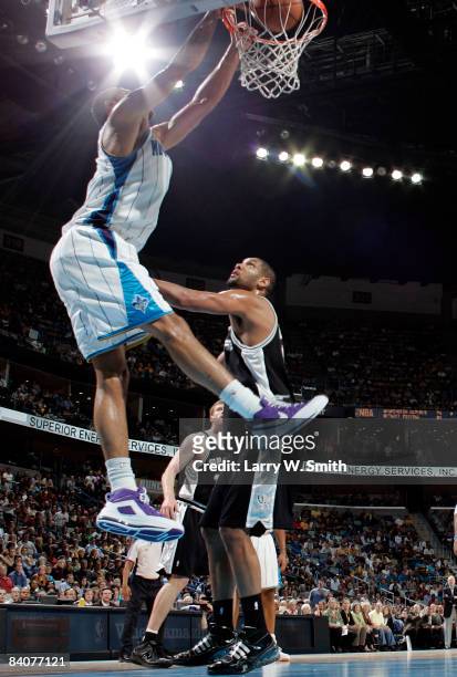 Tyson Chandler of the New Orleans Hornets dunks on Tim Duncan of the San Antonio Spurs at the New Orleans Arena December 17, 2008 in New Orleans,...