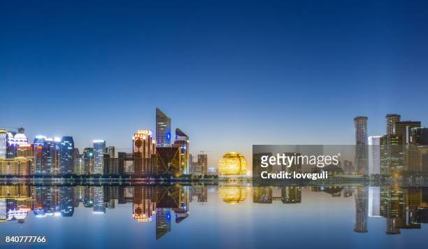 stadtbild von moderne stadt in der nähe fluss im morgengrauen - hangzhou stock-fotos und bilder