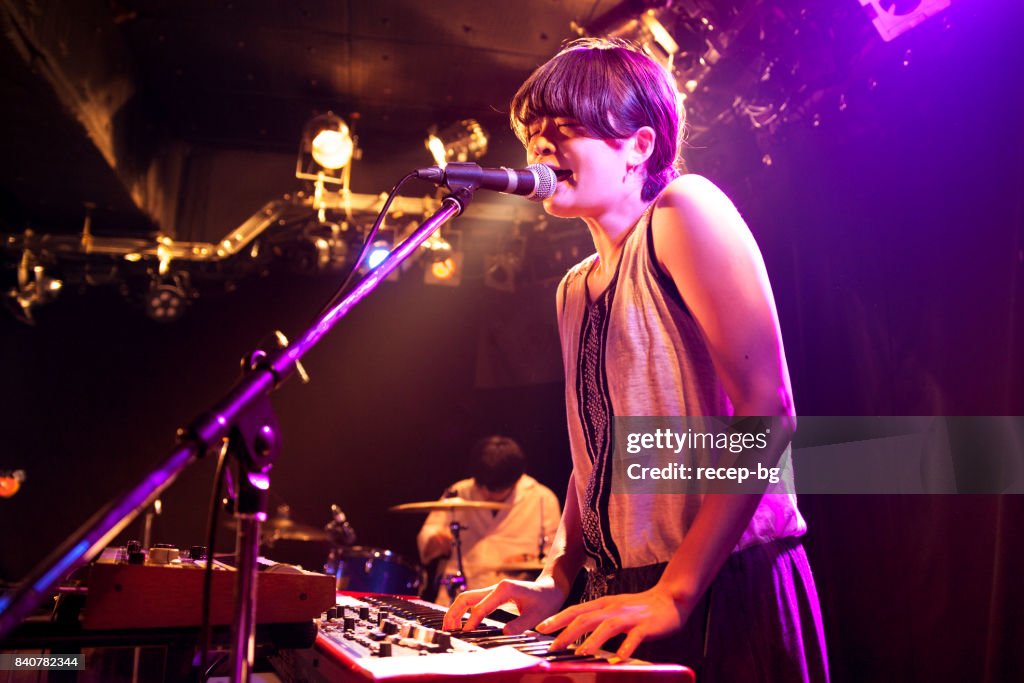 Woman Playing Electronic Keyboard At Live Event