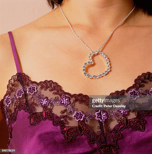 woman wearing valentines day heart shaped gift - heart locket stock-fotos und bilder