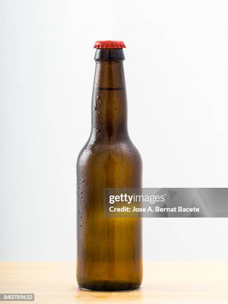 bottle of beer with the frosted glass with drops of water  on a white background - bottle top stock-fotos und bilder