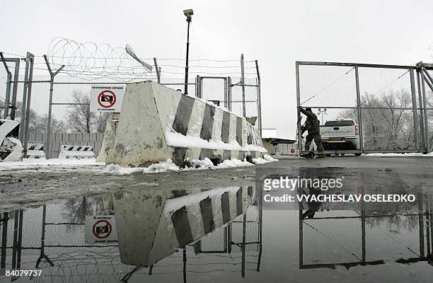 Troops guard the main access checkpoint to the airforce base 30 km outside of Bishkek in Manas on December 18, 2008. Kyrgyzstan is moving to close...