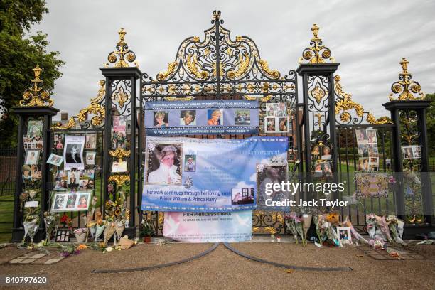 Floral tributes, photographs and messages sit outside an entrance gate to Kensington Palace ahead of the 20th anniversary of the death of Diana,...