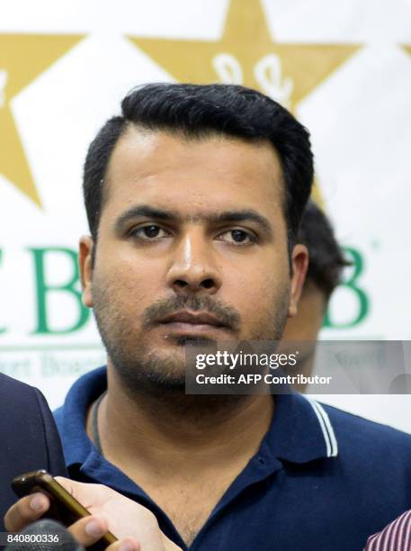 Pakistani cricketer Sharjeel Khan stands with his lawyer after the anti-corruption tribunal's decision in Lahore on August 30, 2017. Pakistan's...