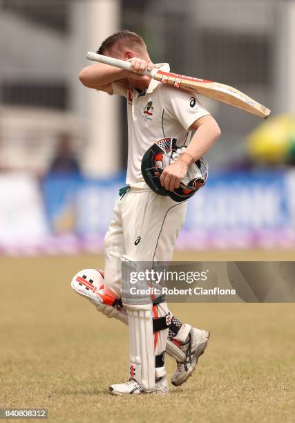 David Warner of Australia walks off the ground after he was dismissed by Shakib Al Hasan of Bangladesh during day four of the First Test match...