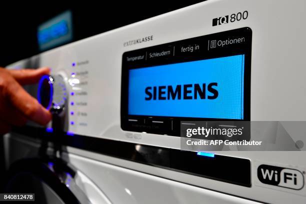 The displays of an "IQ800" washing machine is pictured at the booth of Siemens during the consumer electronics fair IFA in Berlin on August 30, 2017....