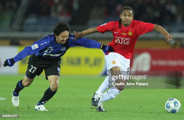 Anderson of Manchester United clashes with Hideo Hashimoto of Gamba Osaka during the FIFA World Club Cup Semi-Final match between Gamba Osaka and...