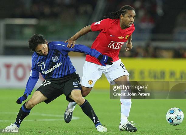 Anderson of Manchester United clashes with Hideo Hashimoto of Gamba Osaka during the FIFA World Club Cup Semi-Final match between Gamba Osaka and...