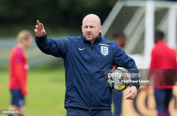 Coach Lee Carsley gives instructions during an England Under 21 training session at St George's Park on August 30, 2017 in Burton-upon-Trent, England.