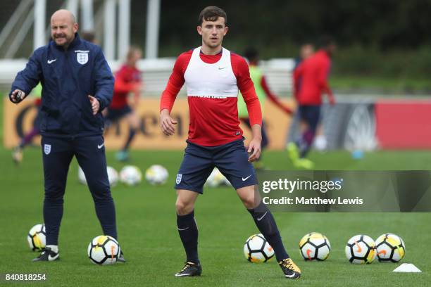 Ben Chilwell of England looks on with coach Lee Carsley during an England Under 21 training session at St George's Park on August 30, 2017 in...