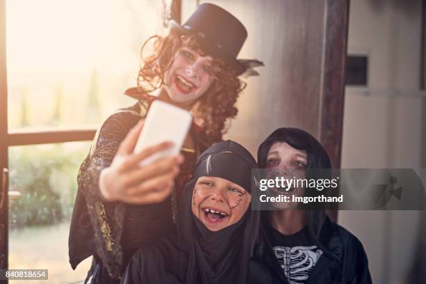 halloween dressed up kinds making selfie - ninja kid stock pictures, royalty-free photos & images