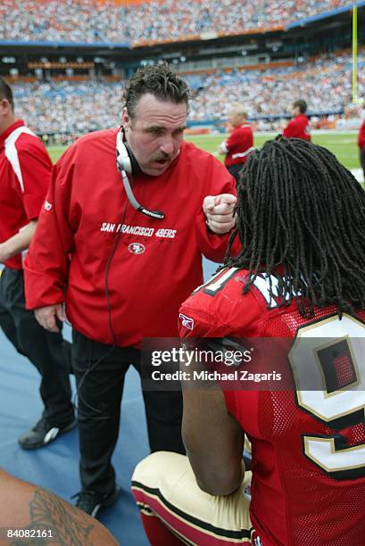 Jim Tomsula meets with Ray McDonald of the San Francisco 49ers during an NFL game against the Miami Dolphins at Dolphin Stadium on December 14, 2008...