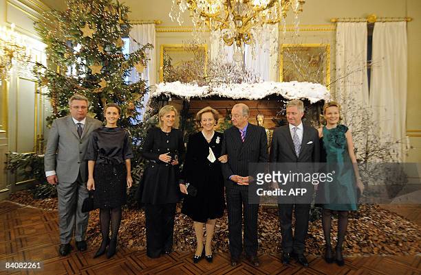Prince Laurent, Princess Claire, Princess Astrid, Queen Paola, King Albert II, Prince Philippe and Princess Mathilde pose before the Christmas...