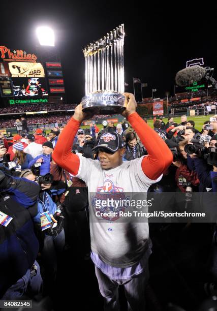 Ryan Howard of the Philadelphia Phillies raises the World Series trophy after defeating the Tampa Bay Rays during the continuation of game five of...