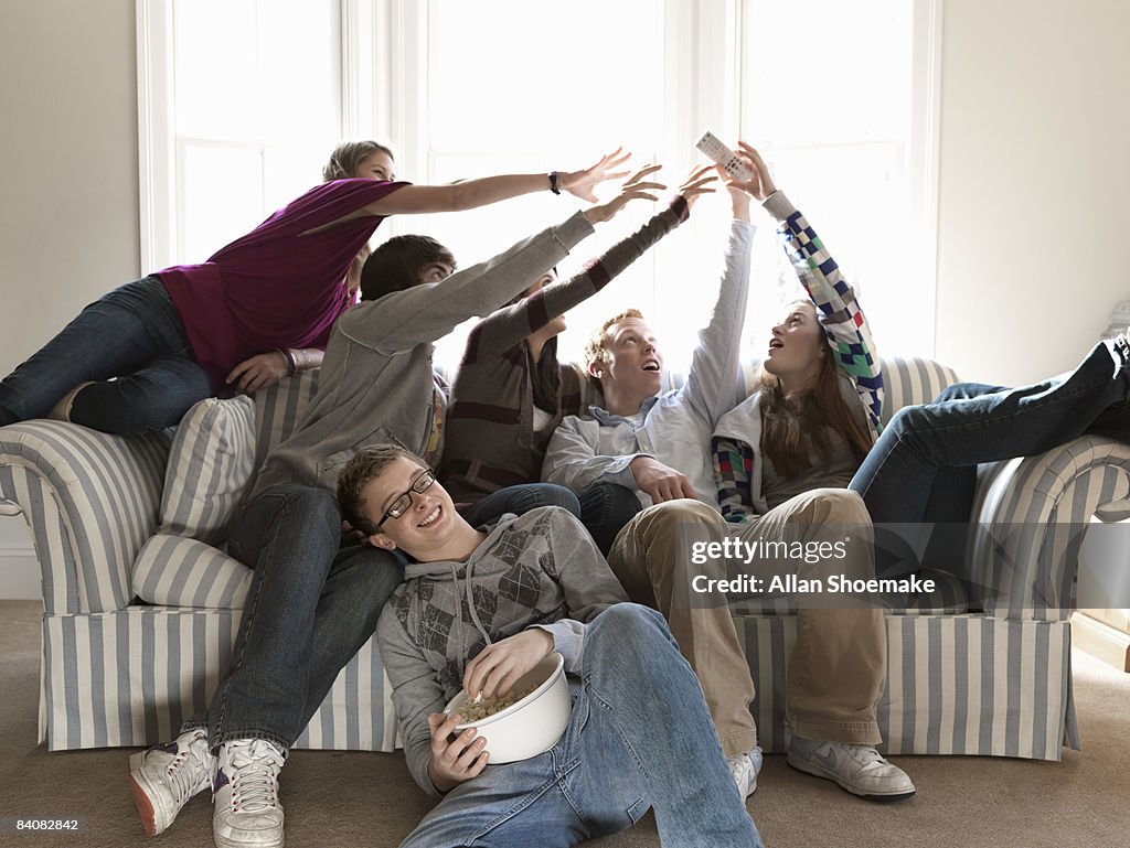 Teen Friends Fighting for Remote