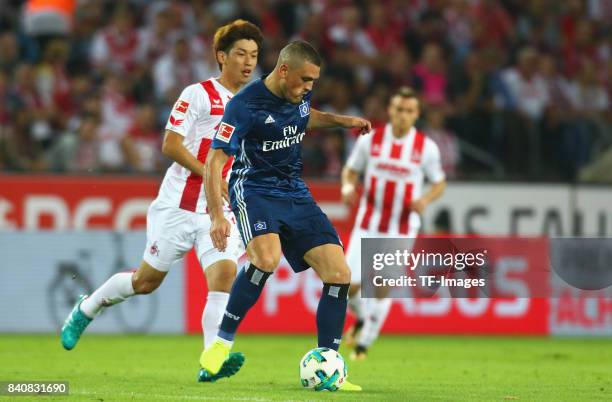 Kiriakos Papadopoulos of Hamburg battle for the ball during the Bundesliga match between 1. FC Koeln and Hamburger SV at Rheinenergiestadion on...