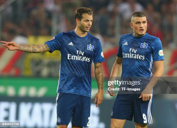 Kiriakos Papadopoulos of Hamburg speak with t Dennis Diekmeier during the Bundesliga match between 1. FC Koeln and Hamburger SV at...