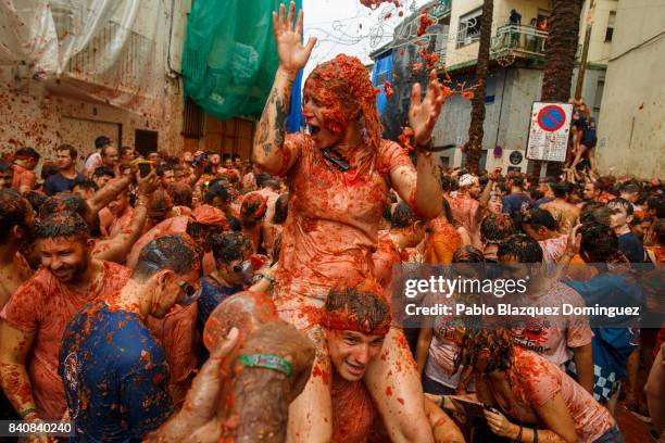 Revellers enjoy the atmosphere in tomato pulp while participating the annual Tomatina festival on August 30, 2017 in Bunol, Spain. An estimated...