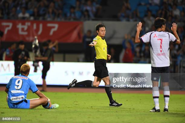 Referee Hiroyuki Kimura points the penalty spot to award the penalty kick to Kawasaki Frontale during the J.League Levain Cup quarter final first leg...