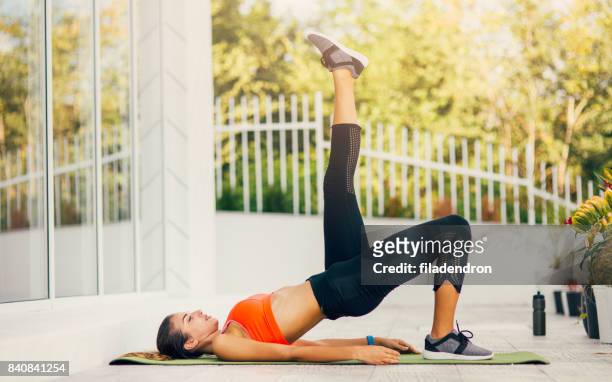 woman exercising on a porch - bottom stock pictures, royalty-free photos & images
