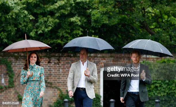Catherine, Duchess of Cambridge, Prince William, Duke of Cambridge and Prince Harry are seen during a visit to The Sunken Garden at Kensington Palace...