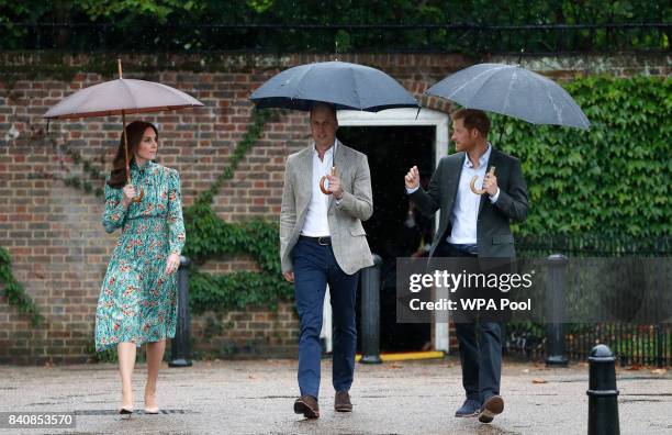 Catherine, Duchess of Cambridge, Prince William, Duke of Cambridge and Prince Harry are seen during a visit to The Sunken Garden at Kensington Palace...