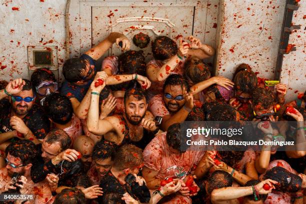 Revellers enjoy the atmosphere in tomato pulp while participating the annual Tomatina festival on August 30, 2017 in Bunol, Spain. An estimated...