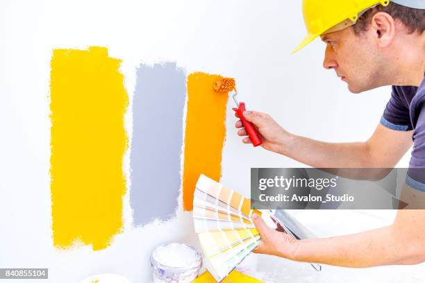 worker choosing paint colors at home - choosing paint stock pictures, royalty-free photos & images