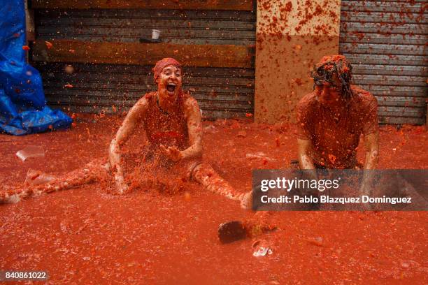 Revellers enjoy the atmosphere in tomato pulp while participating the annual Tomatina festival on August 30, 2017 in Bunol, Spain. An estimated...