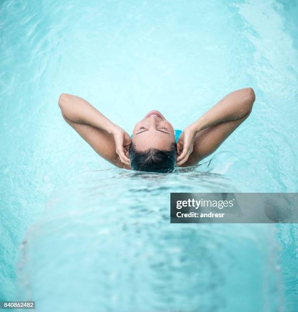 peaceful woman relaxing under a waterfall at the spa - hydrotherapy stock pictures, royalty-free photos & images