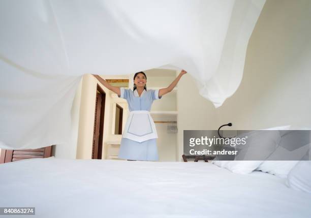 latin american maid working at a hotel - hotel cleaner stock pictures, royalty-free photos & images