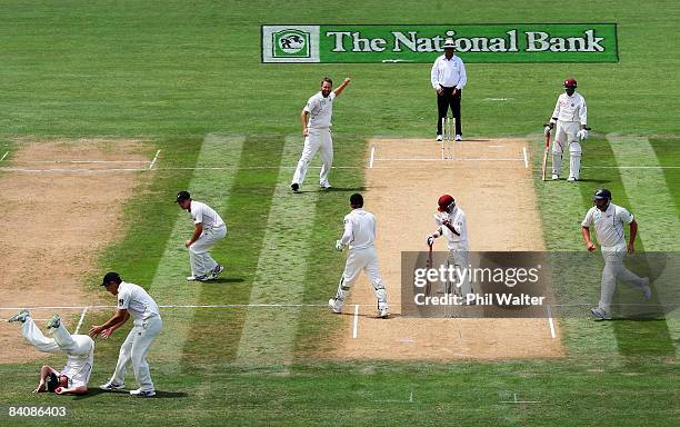 Jamie How of New Zealand rolls over after catching Sewnarine Chattergoon of the West Indies off the bowling of Daniel Vettori during day one of the...